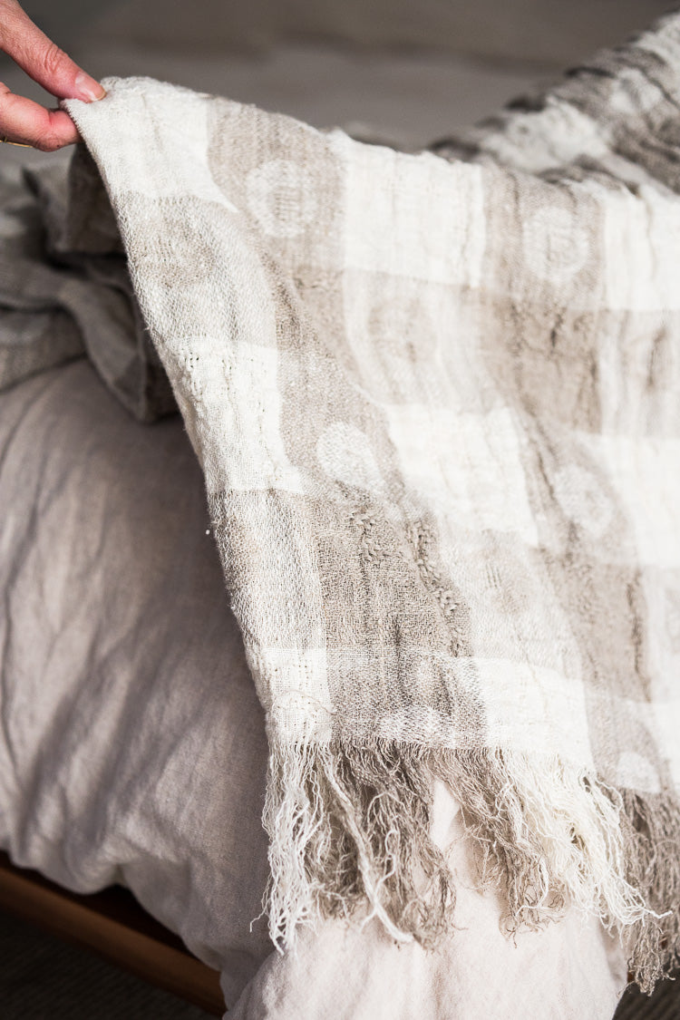 100% linen throw ivory/natural with fringed ends.